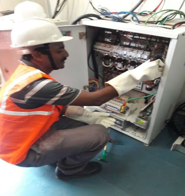 Technician servicing an electrical panel